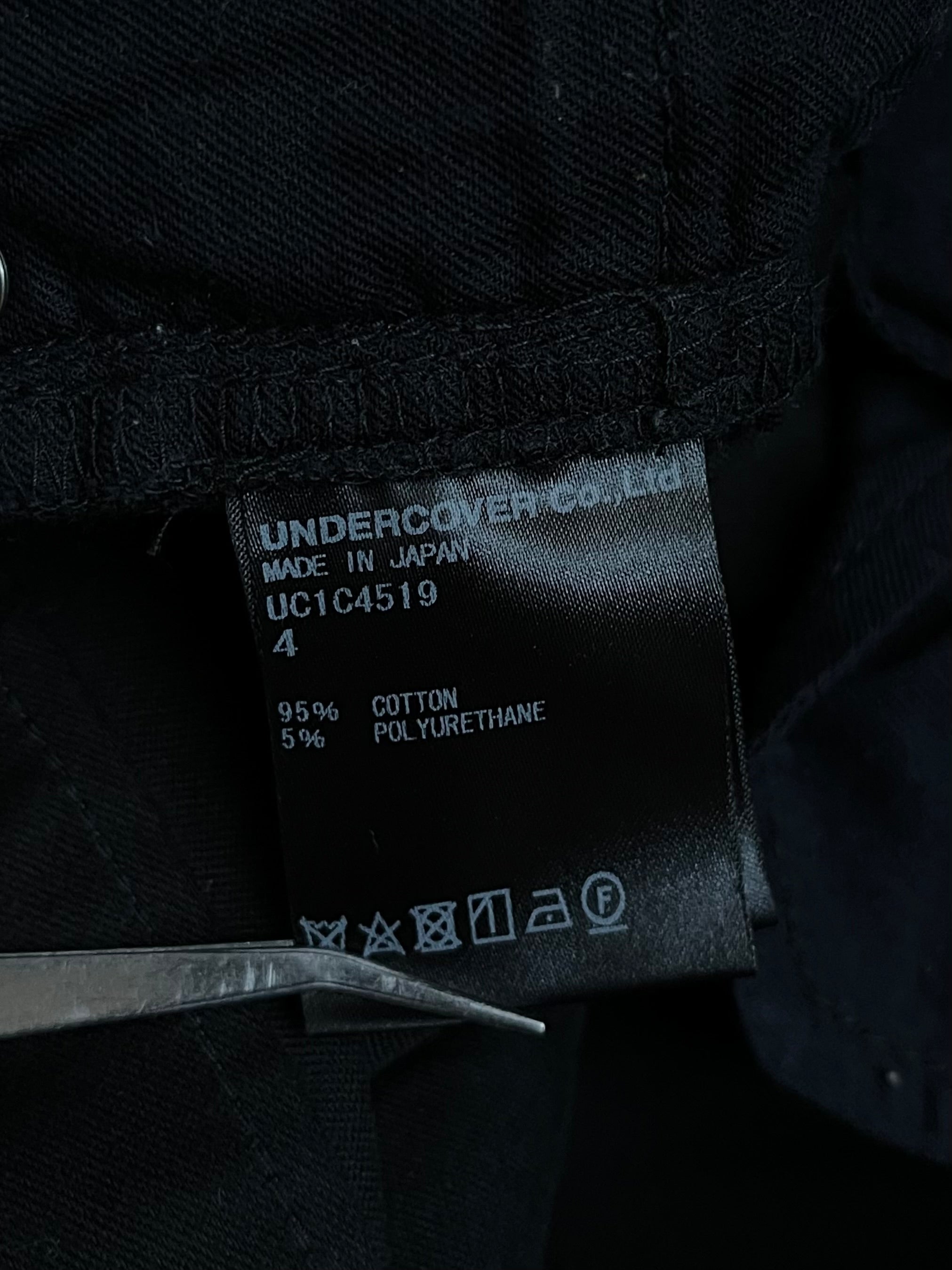 Undercover SS23 Bright Side of the Dark Side Scab distressed denim jeans showing ripped and faded details.