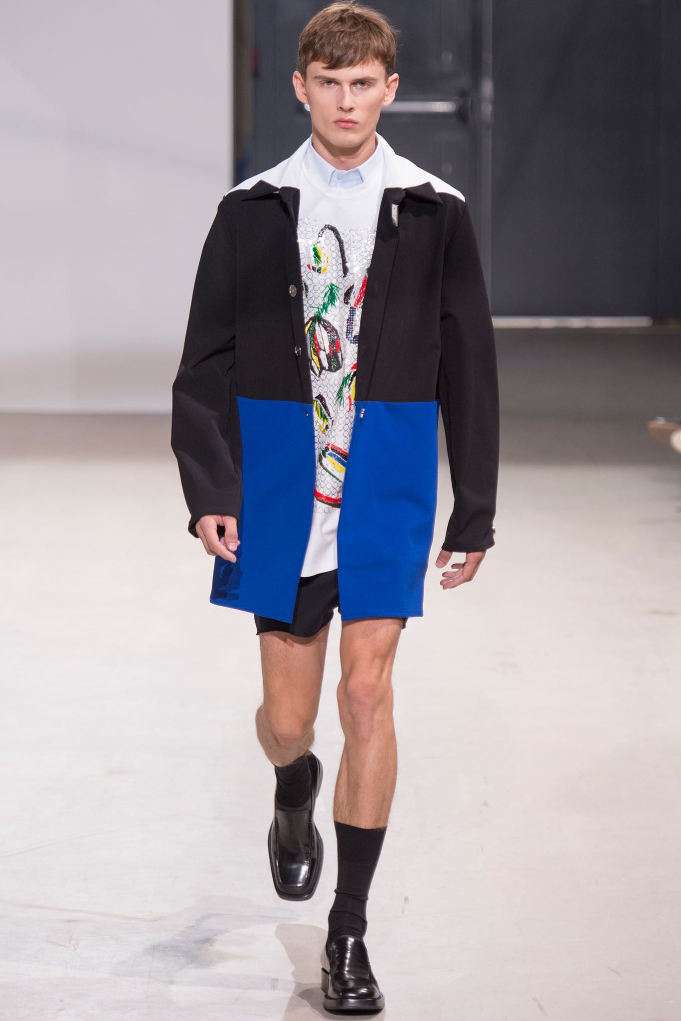 Raf Simons SS14 tri-color athletic long coat with layered design and bold color blocks, displayed on a mannequin.