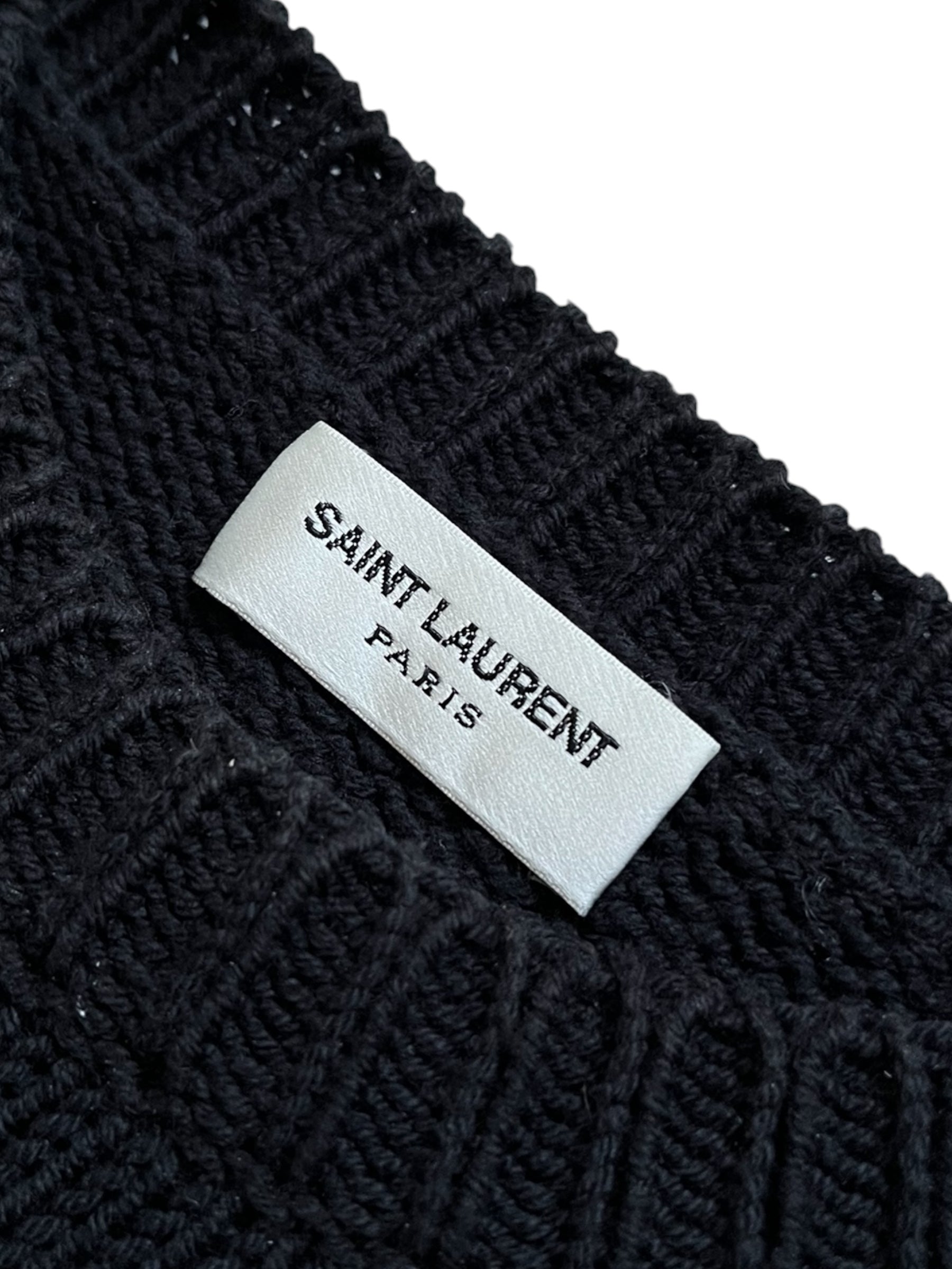Saint Laurent SS16 black knit sweater displayed on a hanger, showcasing its soft knit fabric and classic design.