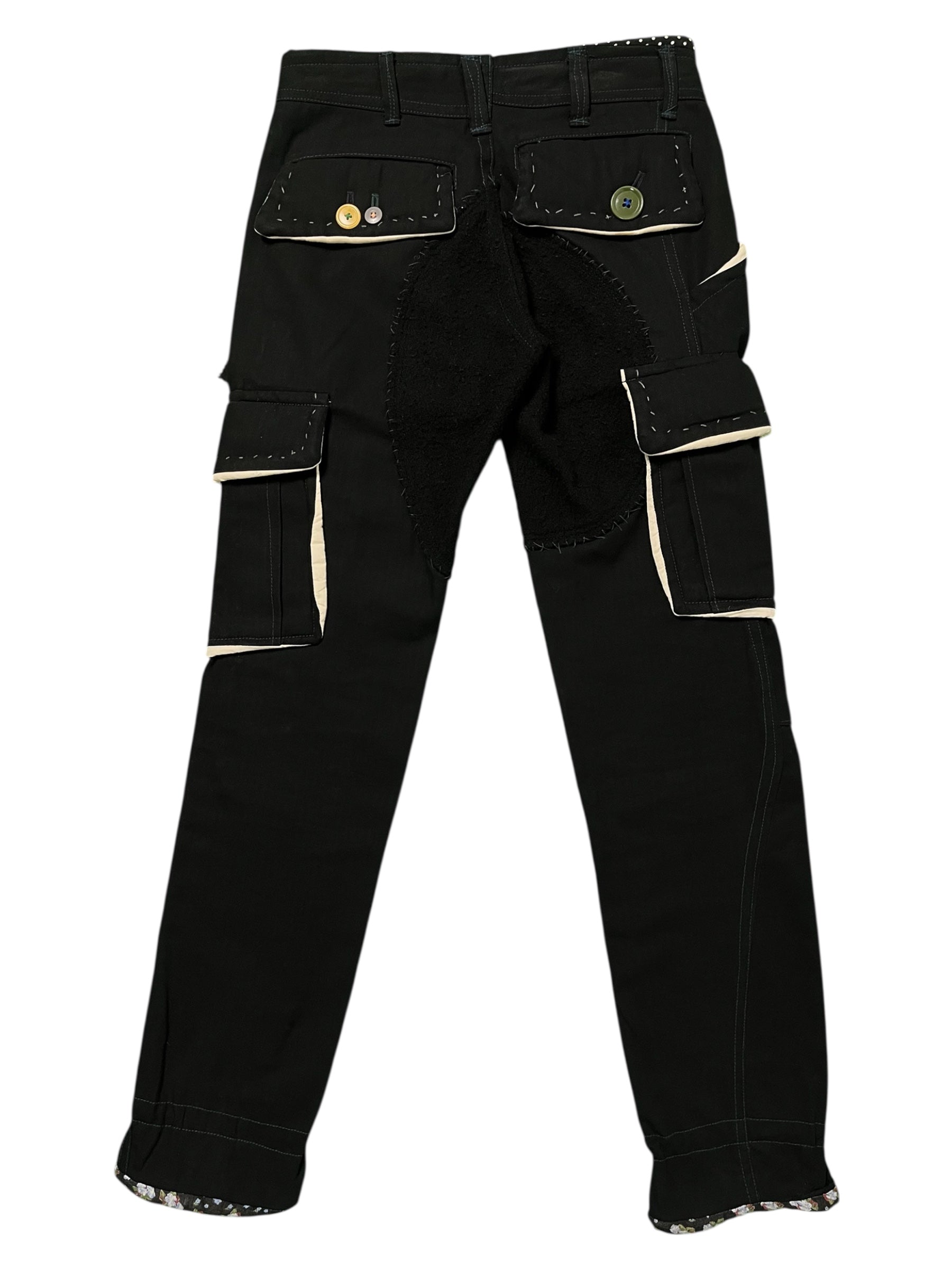Undercover AW04 "But Beautiful" cargo pants featuring parasitic and stuffed details, shown in a stylish natural pose.