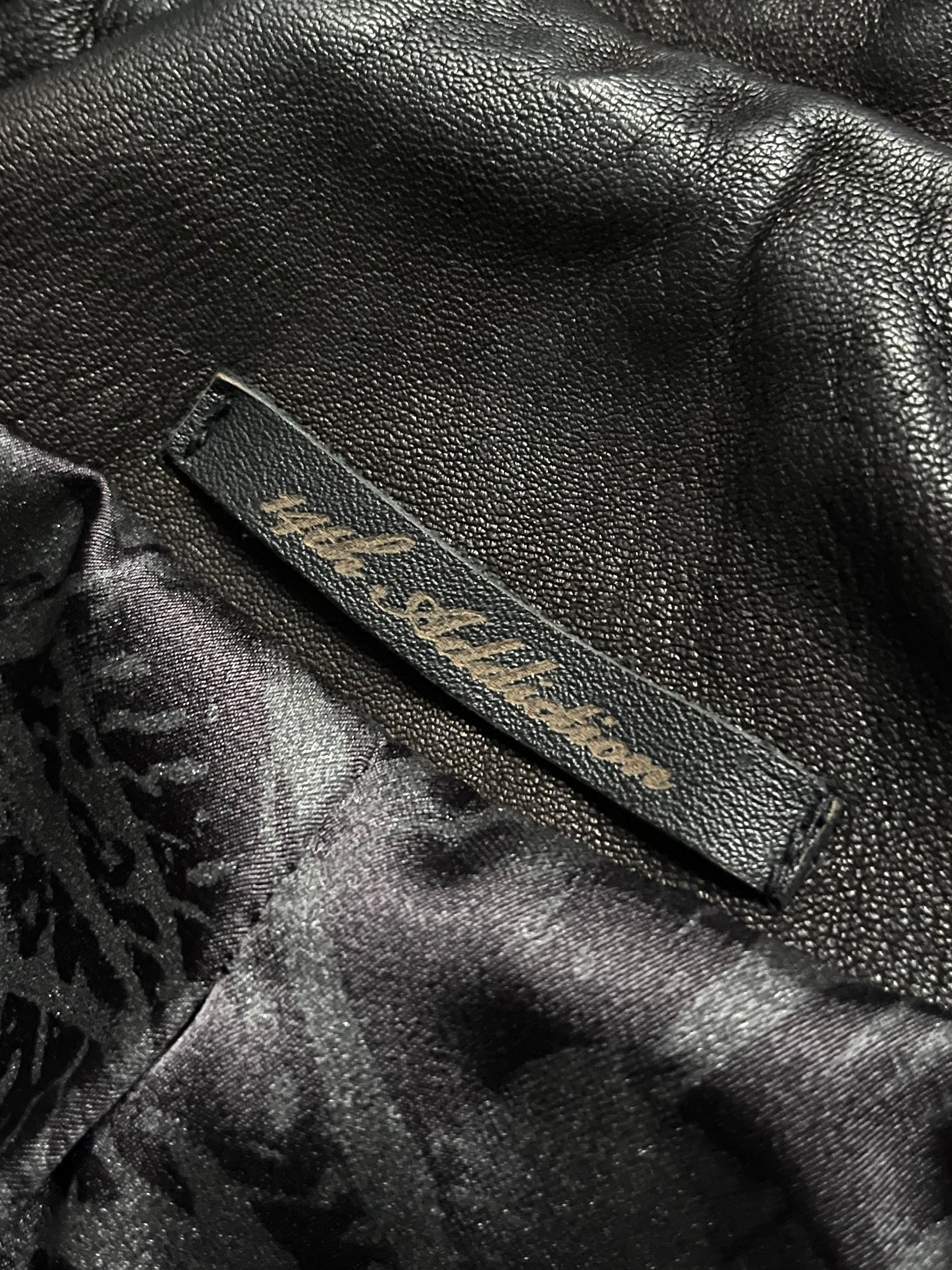 Black sheepskin jacket with cross-zip design by 14th Addiction, featuring a stylish and textured leather exterior.