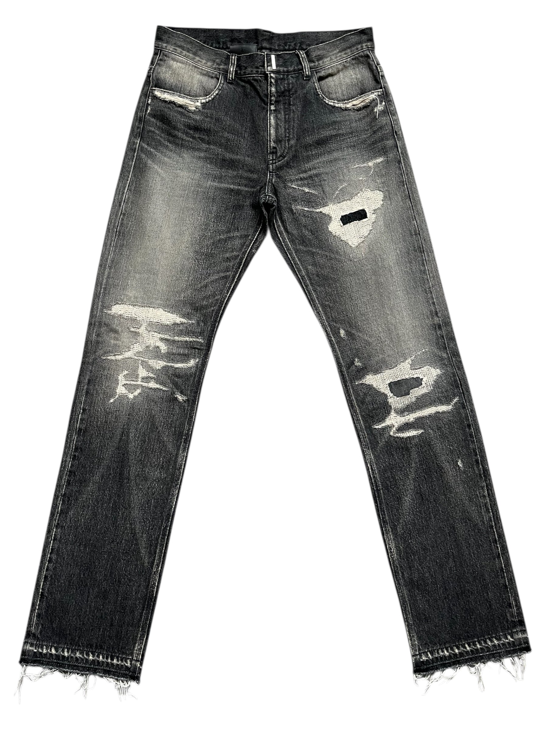 Givenchy FW23 distressed boro black denim pants with ripped details and raw edge design, front view showing fit and fabric texture.