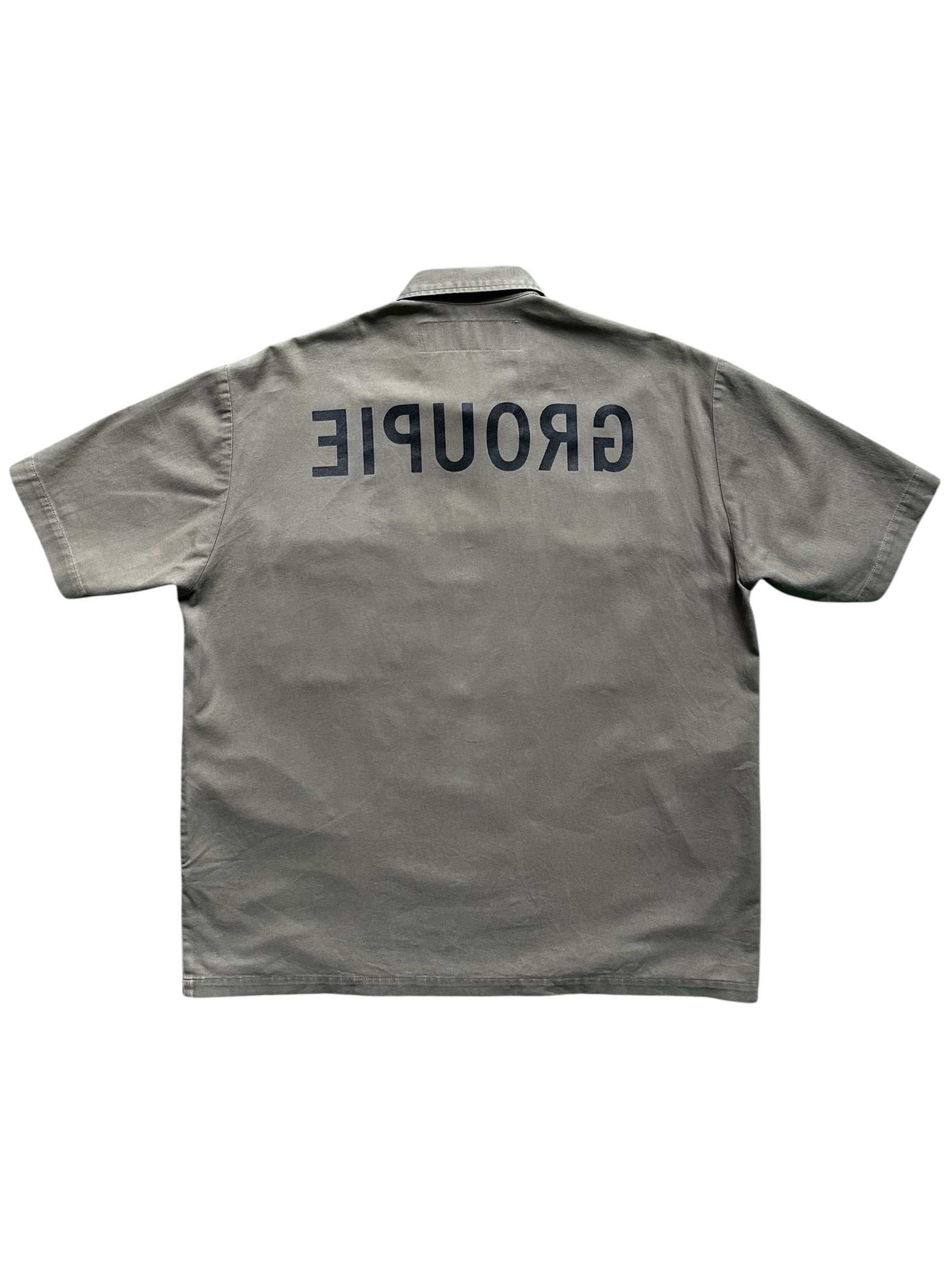 Undercover SS99 "Relief" Groupie military shirt featuring camouflage pattern and button front, casual streetwear style.