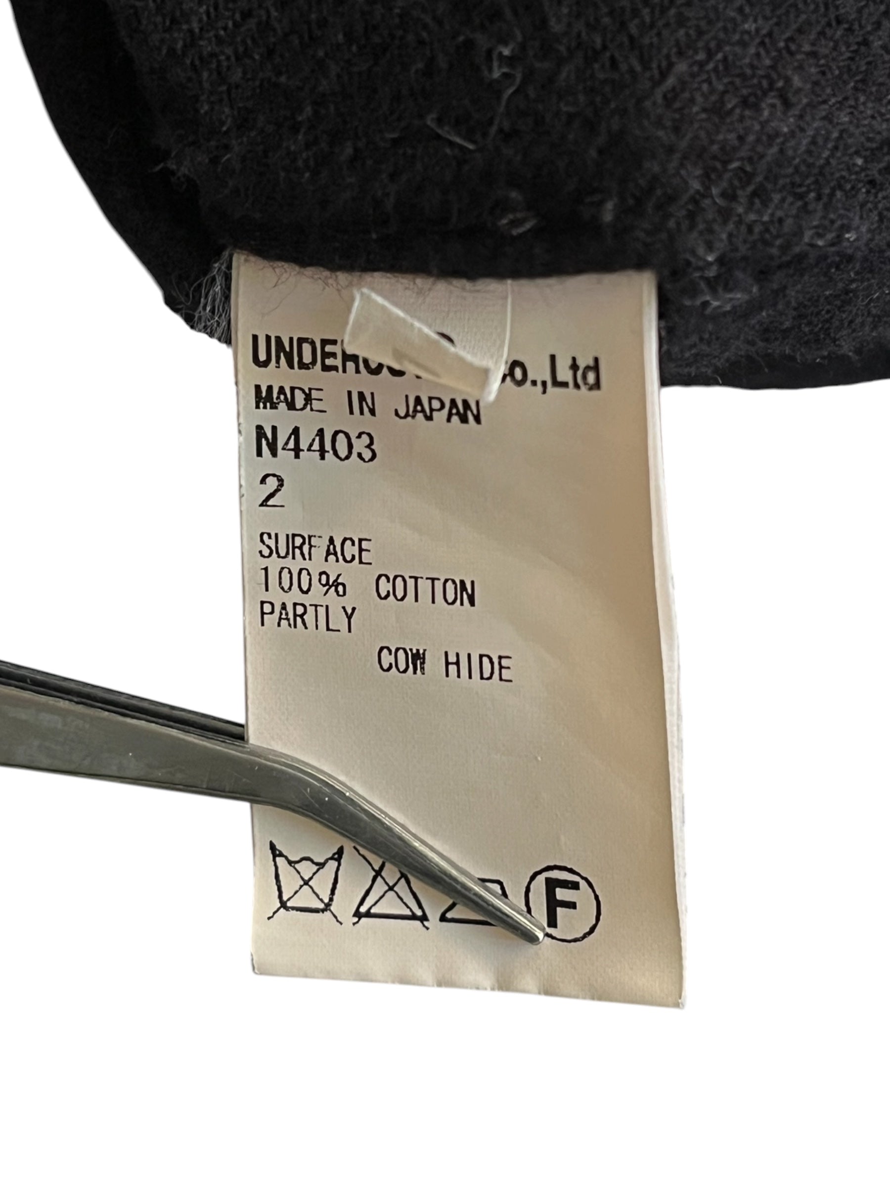 Undercover AW14 "Cold Blood" brushed cotton overshirt, featuring a relaxed fit and detailed stitching, displayed on a hanger.