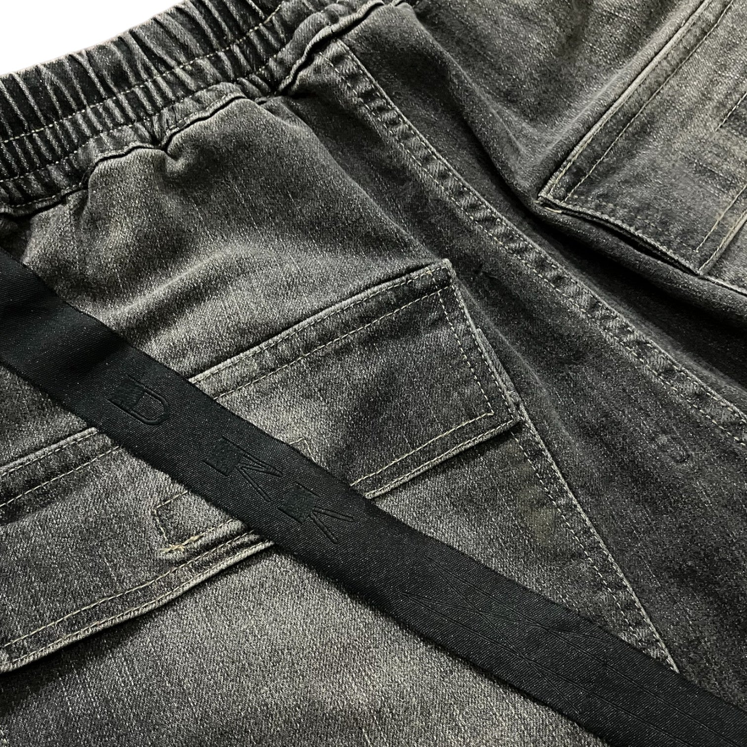 Rick Owens DRKSHDW Bella Double Cargo Denim Pants with multiple pockets and relaxed fit, shown in a dark wash denim.