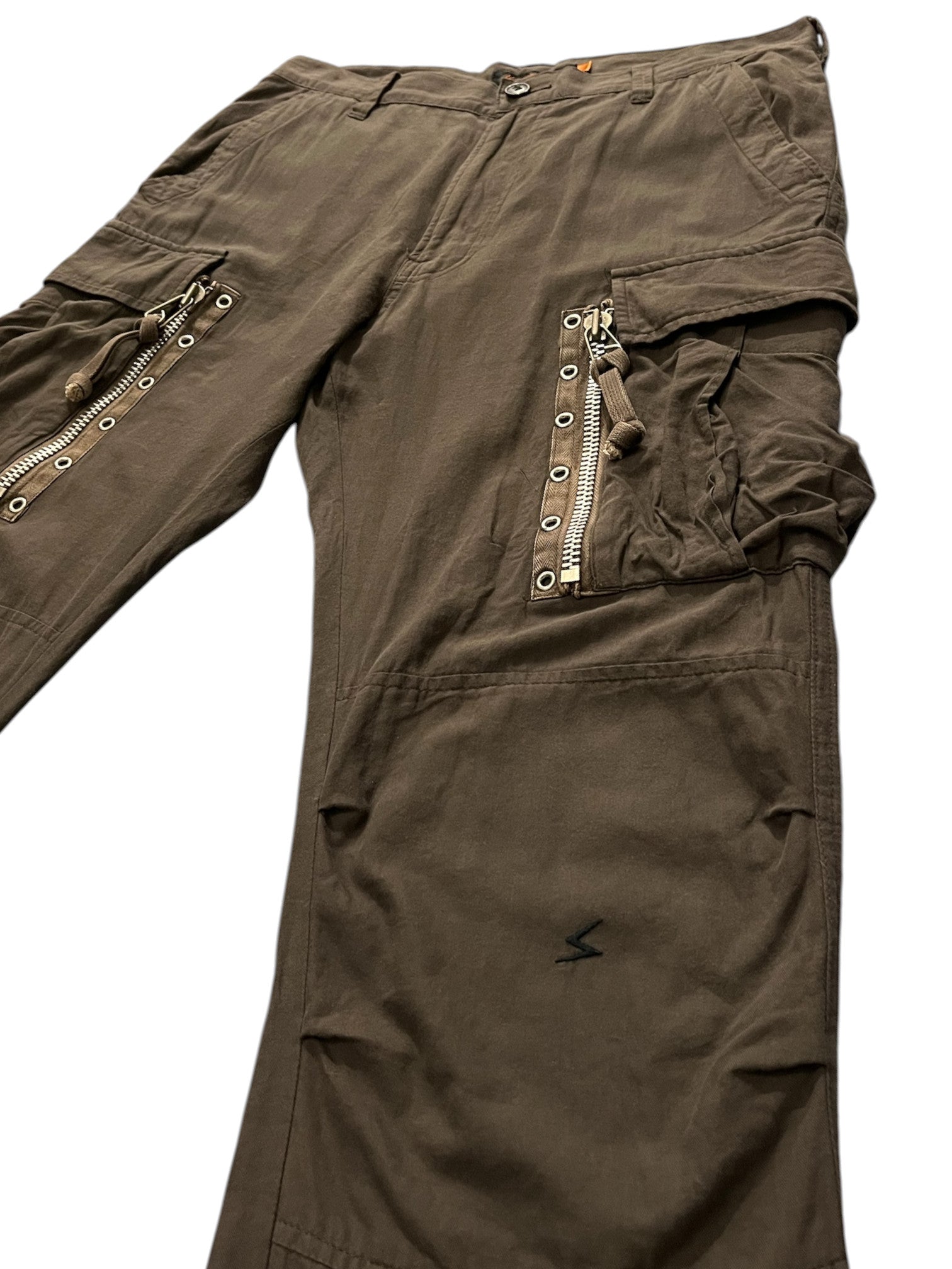 Undercover SS06 “T” military cargo pants with multiple pockets, styled in olive green, displayed on a neutral background.