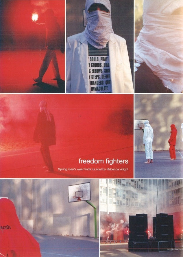 Red Raf Simons SS02 "Woe Onto Those" coverall boiler suit with front zip and utility pockets, styled as a fashion-forward workwear piece.